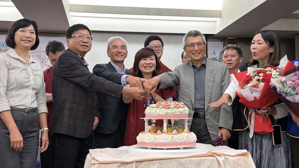 2026臺北溫泉季記者會合照，與會者及身穿彩色服裝的表演者手持鳴子
